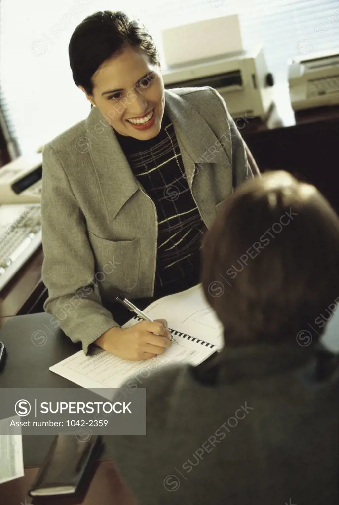 High angle view of a businesswoman interviewing a businessman