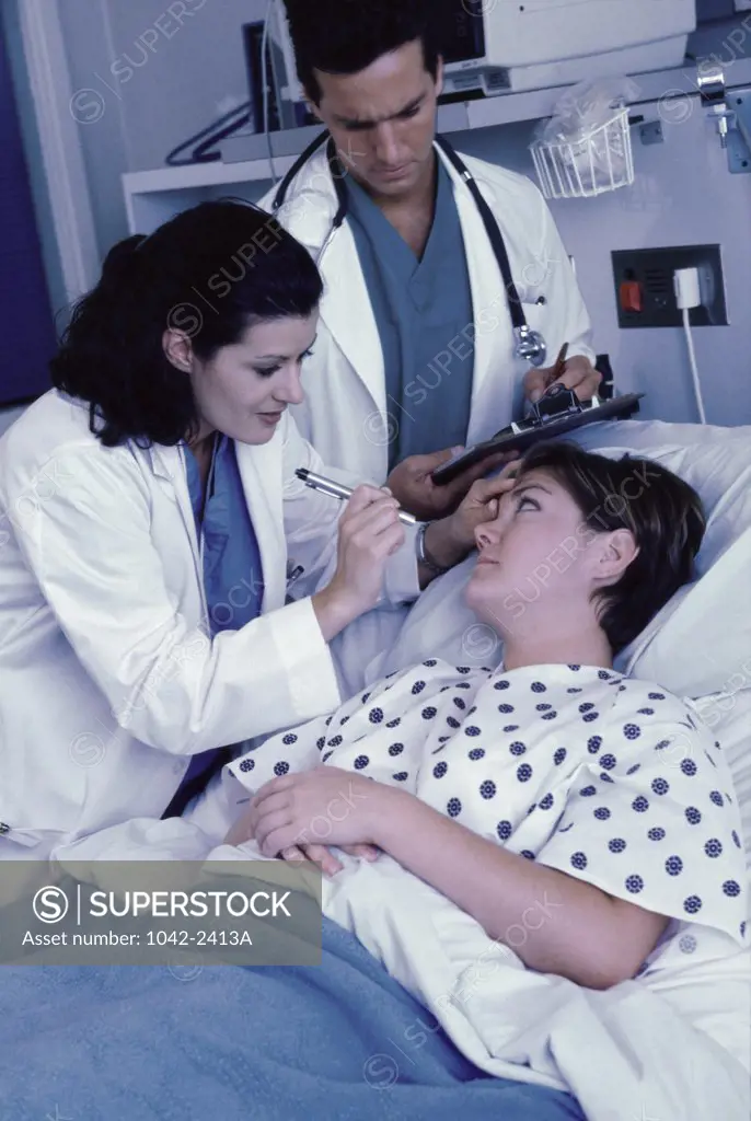 Female doctor examining a female patient's eye