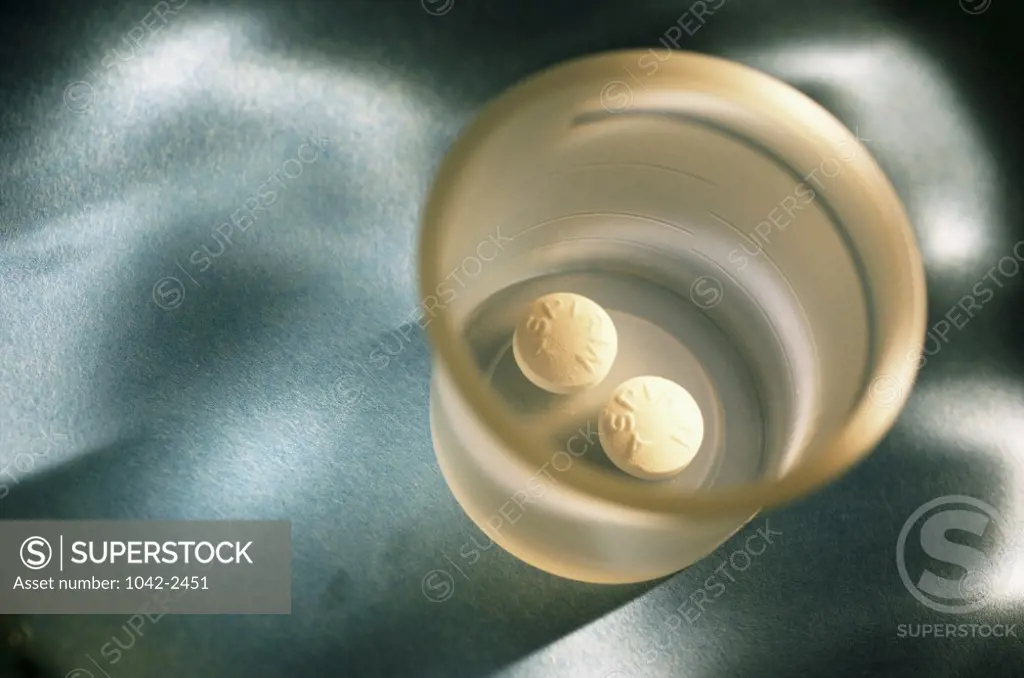 High angle view of two pills in a cup