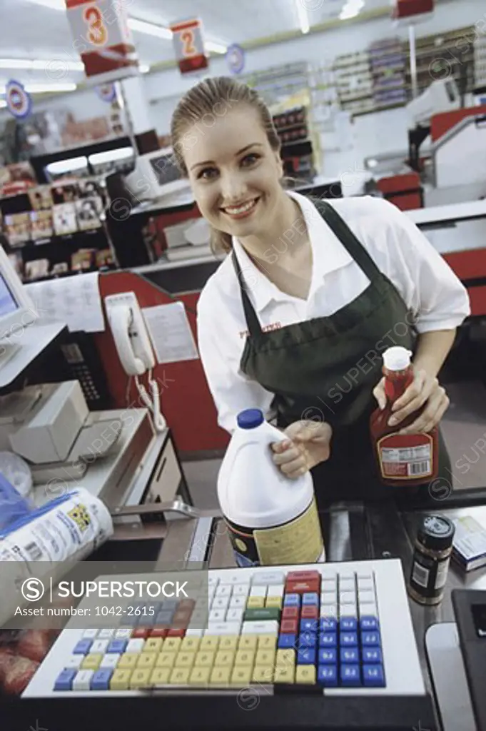 Portrait of a female cashier at the checkout counter in a supermarket