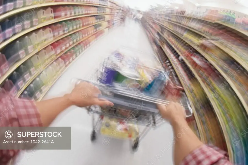 Man pushing a shopping cart in a supermarket