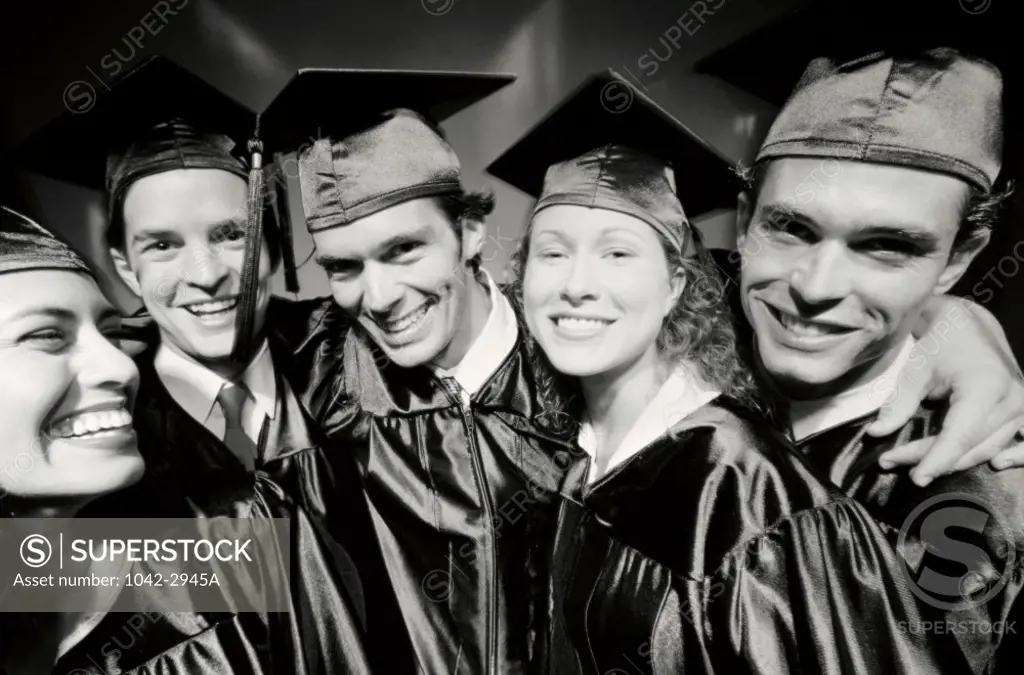Portrait of a group of young graduates standing together