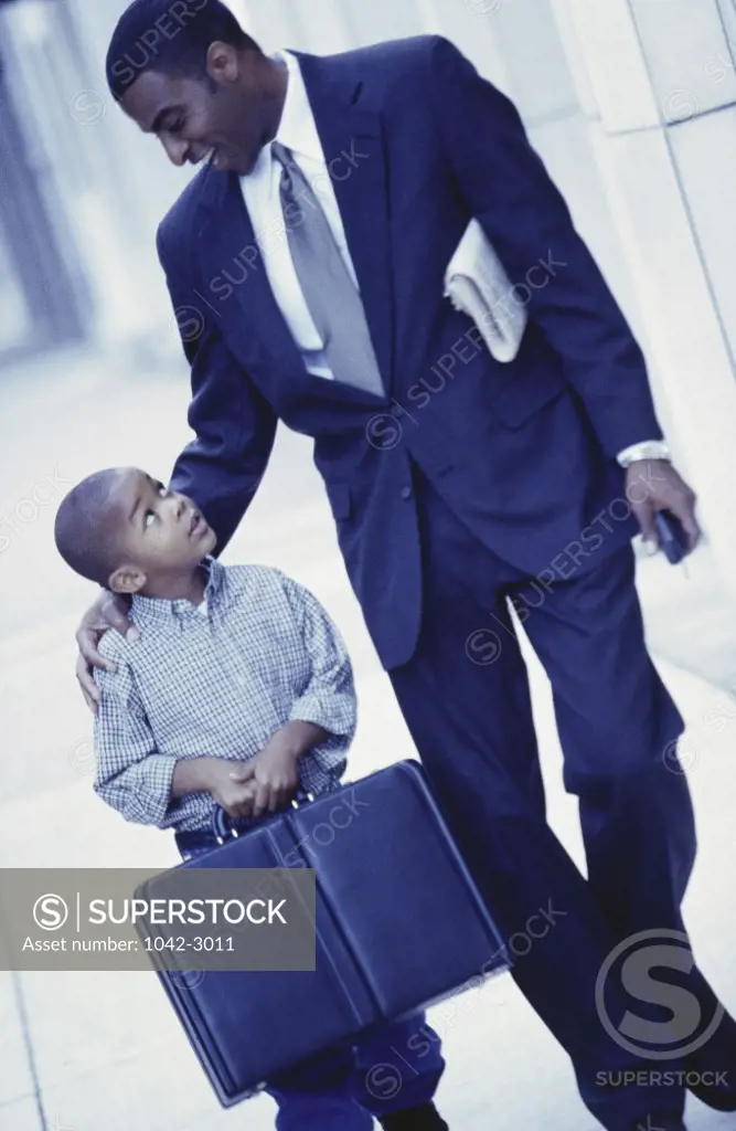 Businessman walking with his son