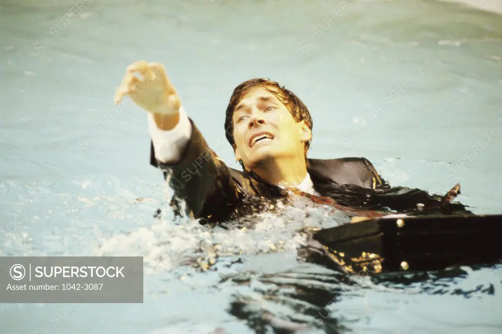 High angle view of a businessman drowning