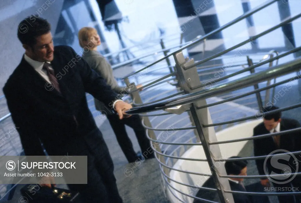 Businessman walking up a spiral staircase