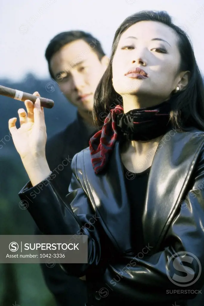 Portrait of a young woman smoking a cigar