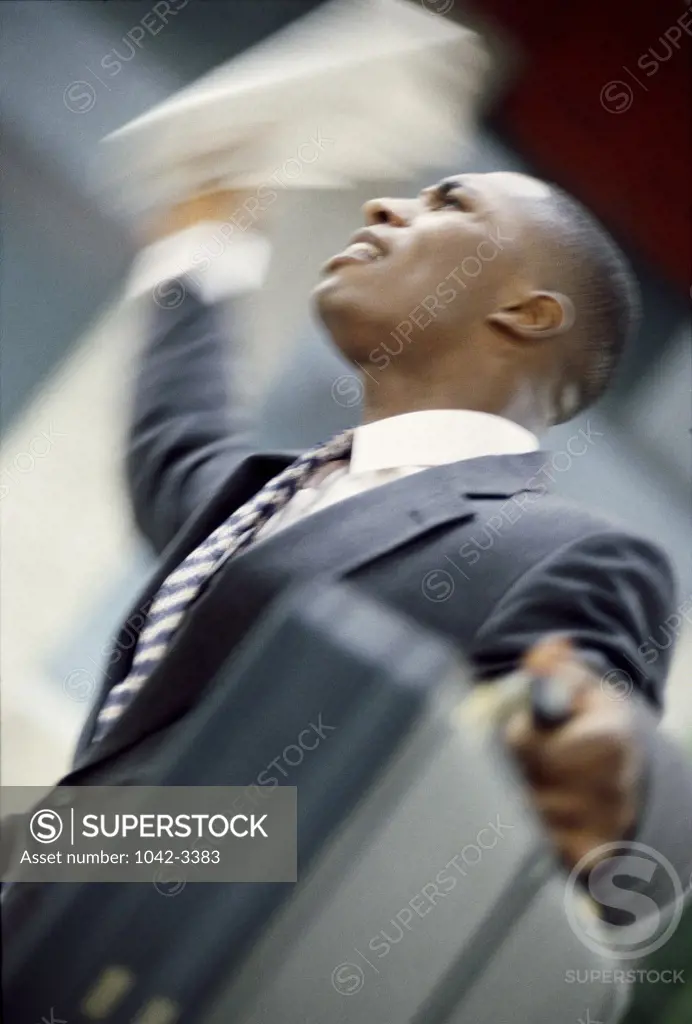 Businessman waving his hand carrying a briefcase