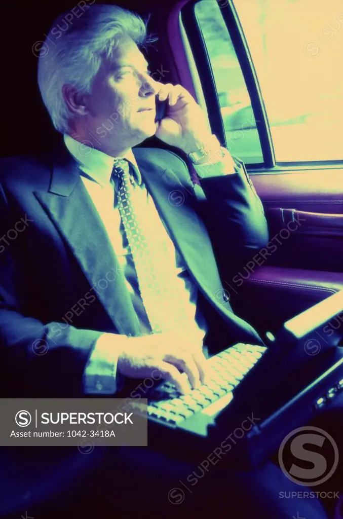 Businessman looking out of a window of a car
