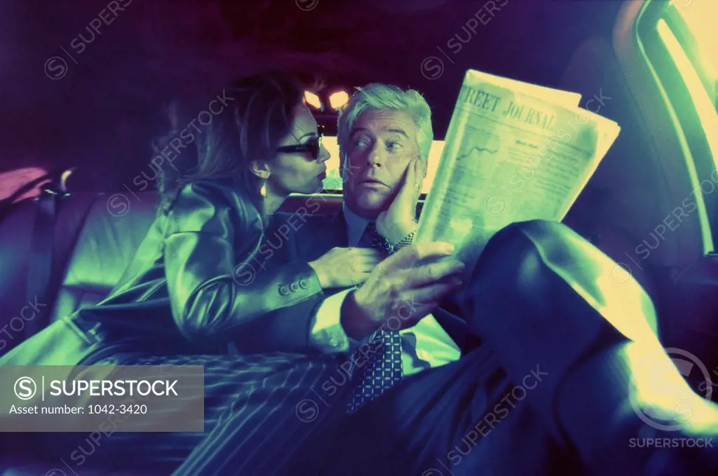Businessman and a businesswoman in a car