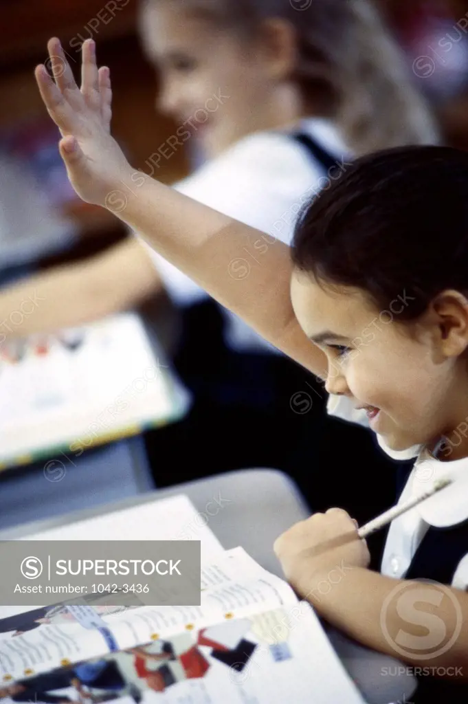 Girl raising her hand in class