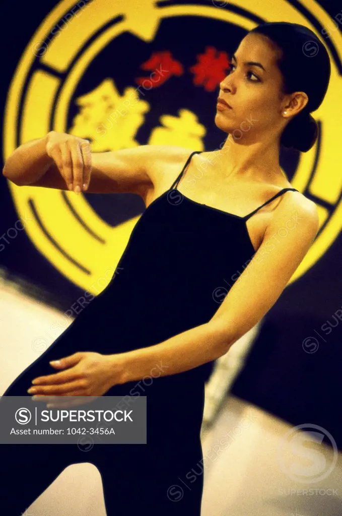 Young woman practicing Tai Chi