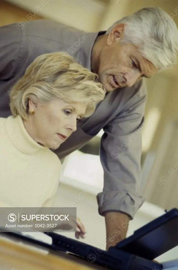 Senior couple using a laptop