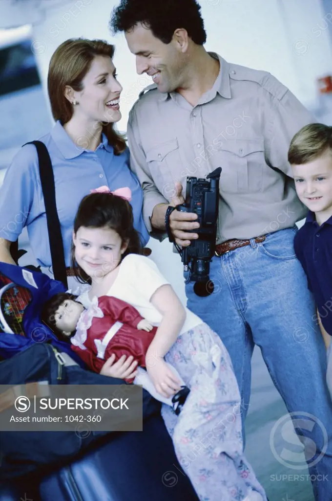 Parents with their son and daughter at an airport