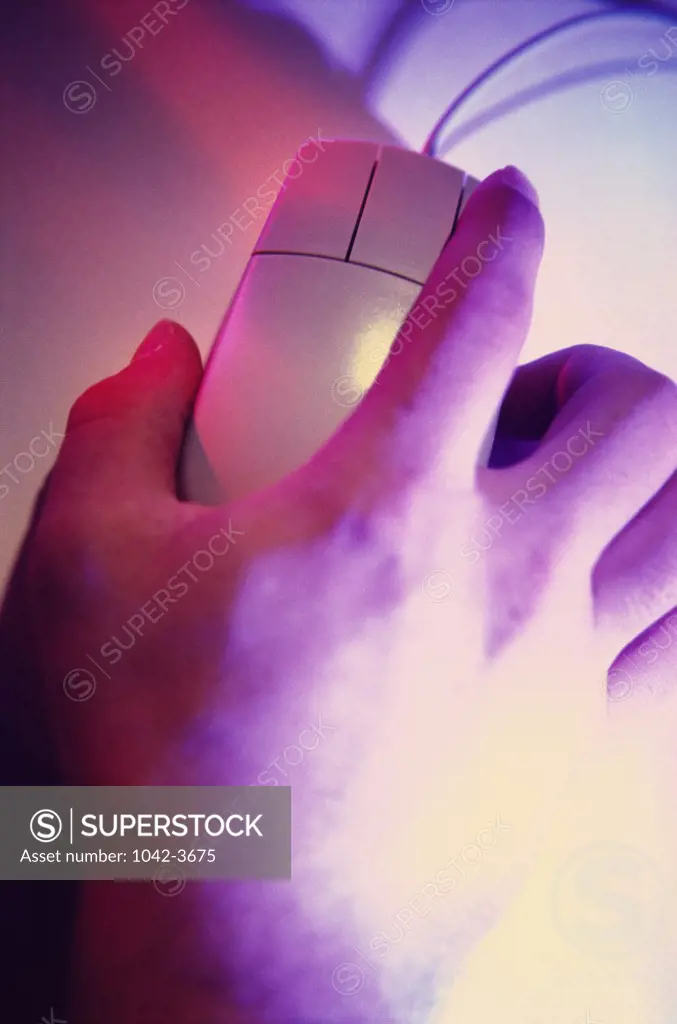 Close-up of a person's hand using a computer mouse