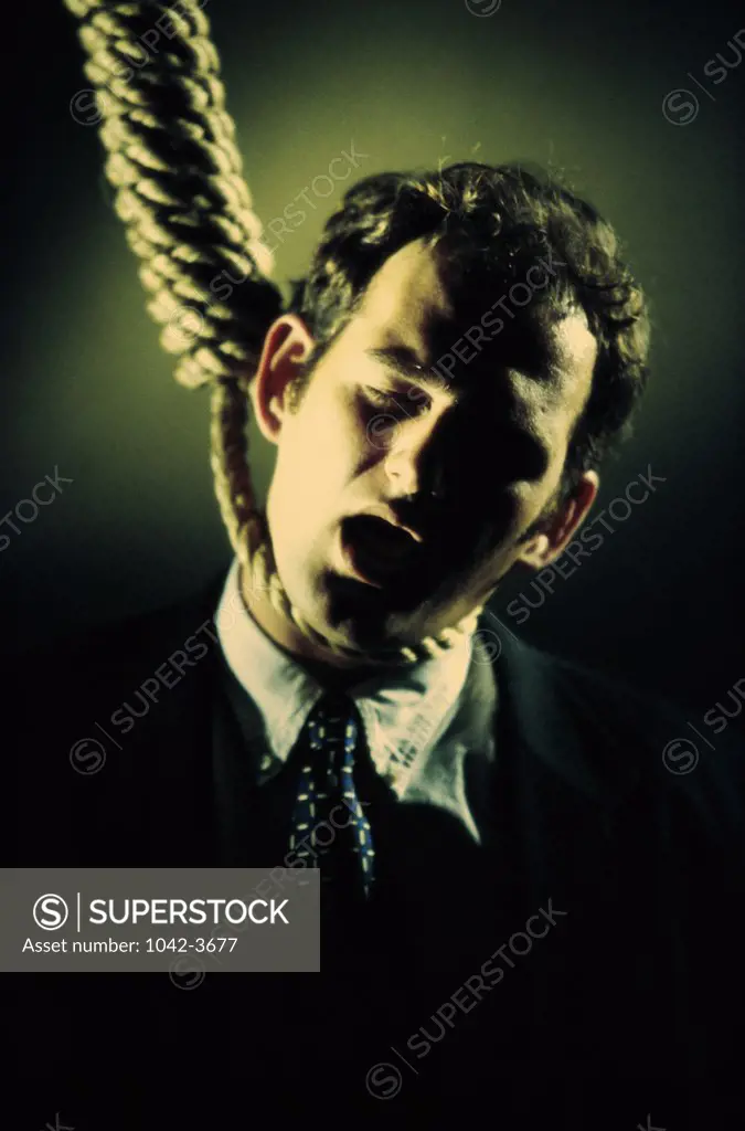 Close-up of a businessman with a noose around his neck