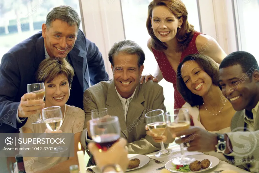 Portrait of a group of people celebrating with white wine and red wine