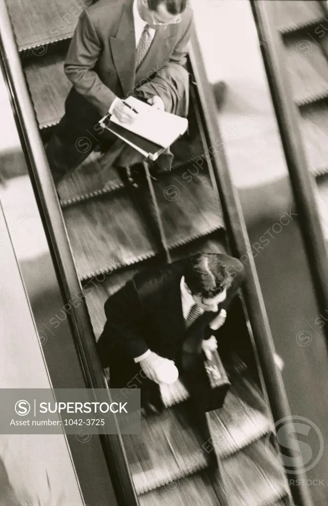 High angle view of two businessmen on an escalator