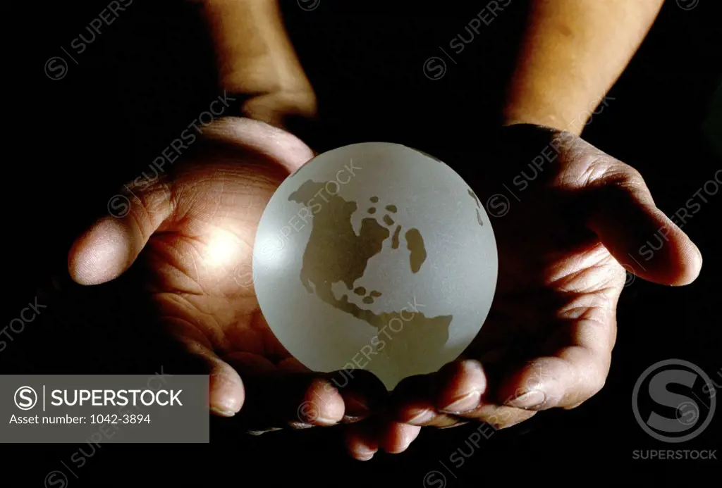 Close-up of a person's hands holding a globe