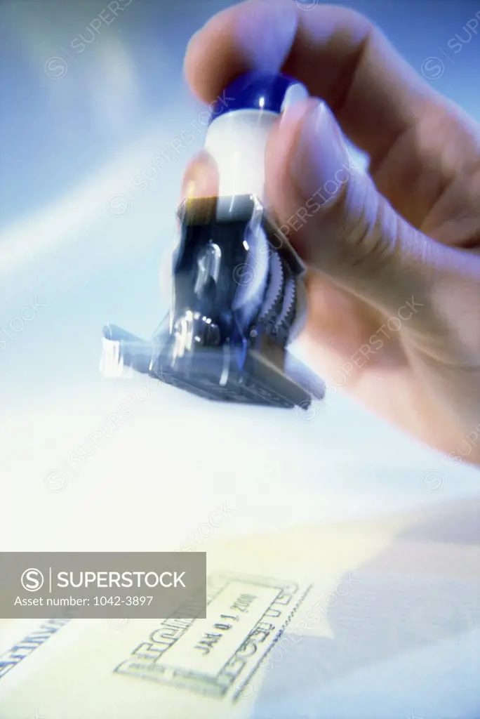 Person holding a rubber stamp