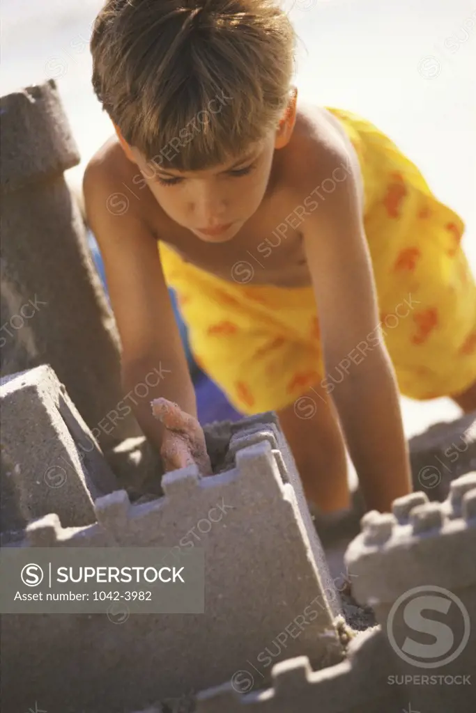 Boy making a sandcastle on the beach