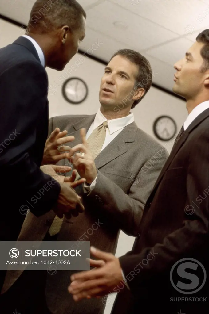 Three businessmen talking in an office