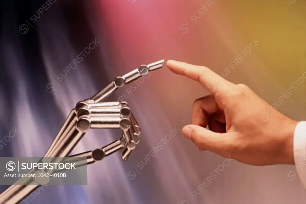 Close-up of a person's finger touching a robot's finger