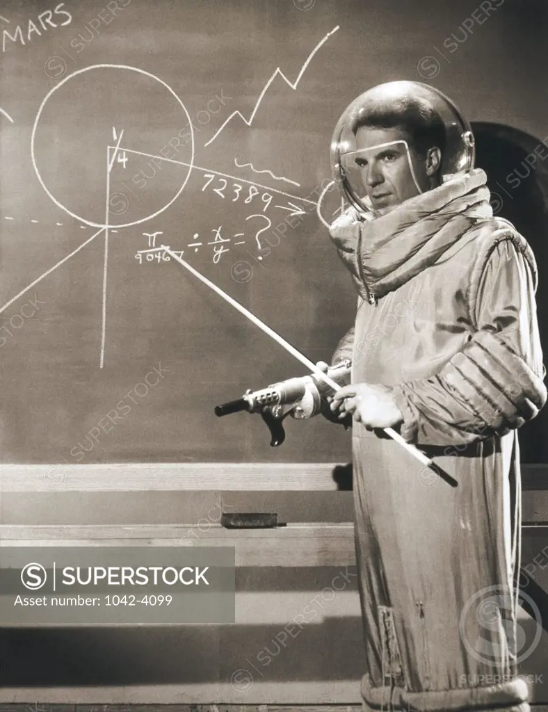 Side profile of an astronaut pointing to a chalkboard
