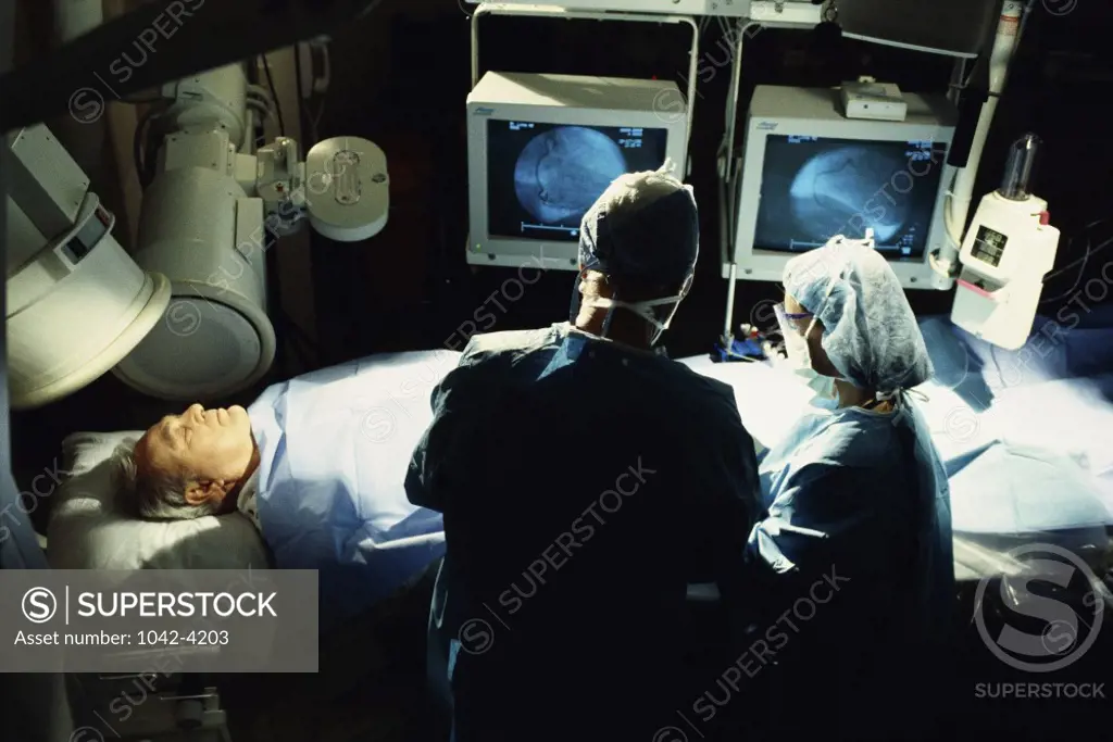 High angle view of two doctors examining a patient