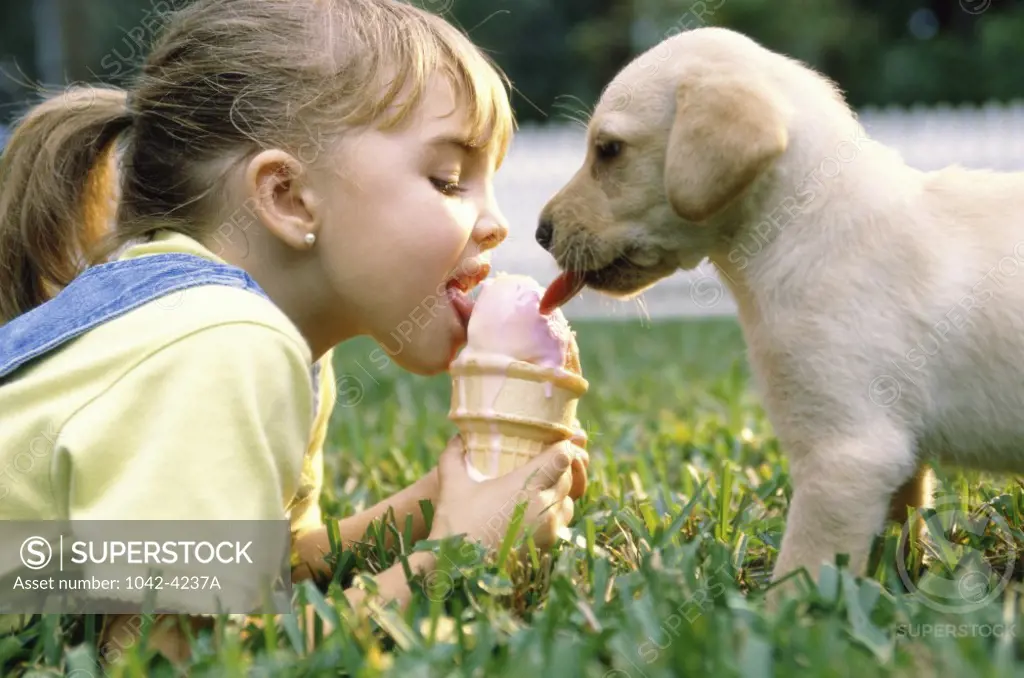 Side profile of a girl licking an ice cream cone with a puppy dog