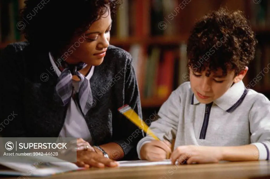 Teacher helping her student in a classroom
