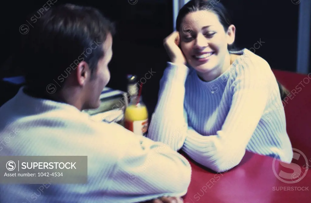 Young couple looking at each other in a restaurant