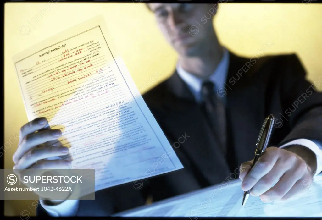 Businessman writing on paper