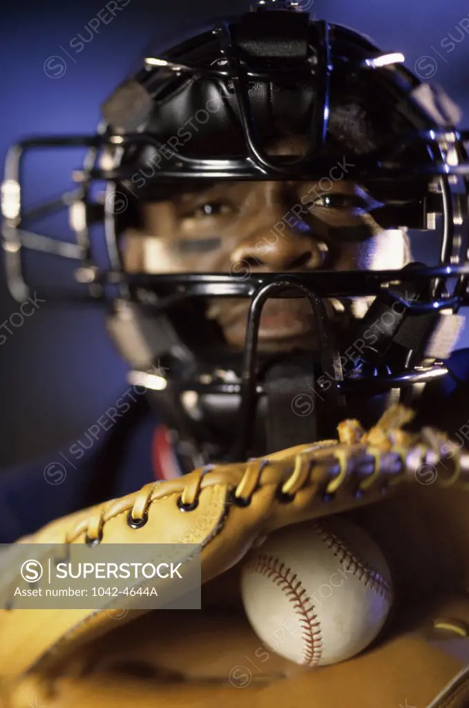 Portrait of a baseball catcher holding a baseball