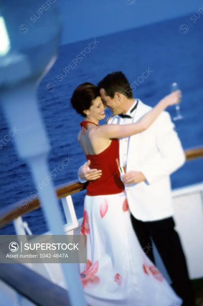 Side profile of a young couple dancing on a cruise ship
