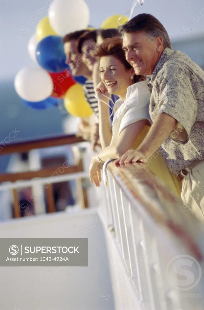 Side profile of a group of people standing on a cruise ship