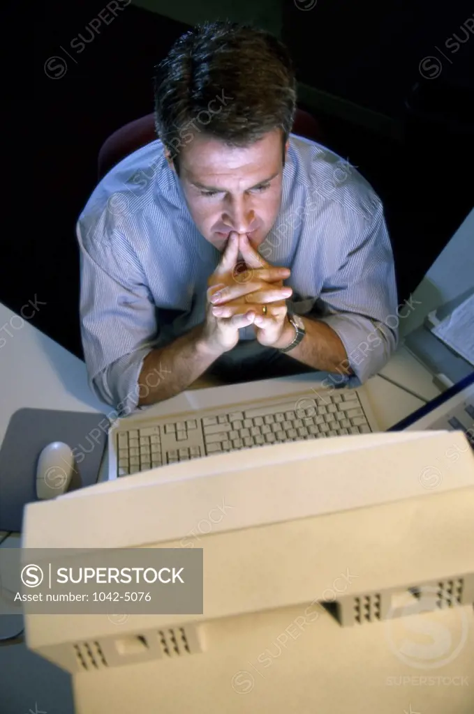 Businessman sitting in front of a computer monitor in an office