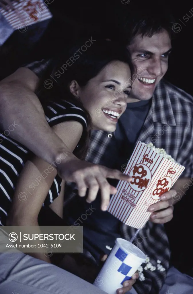 Young couple sitting in a theater watching a movie