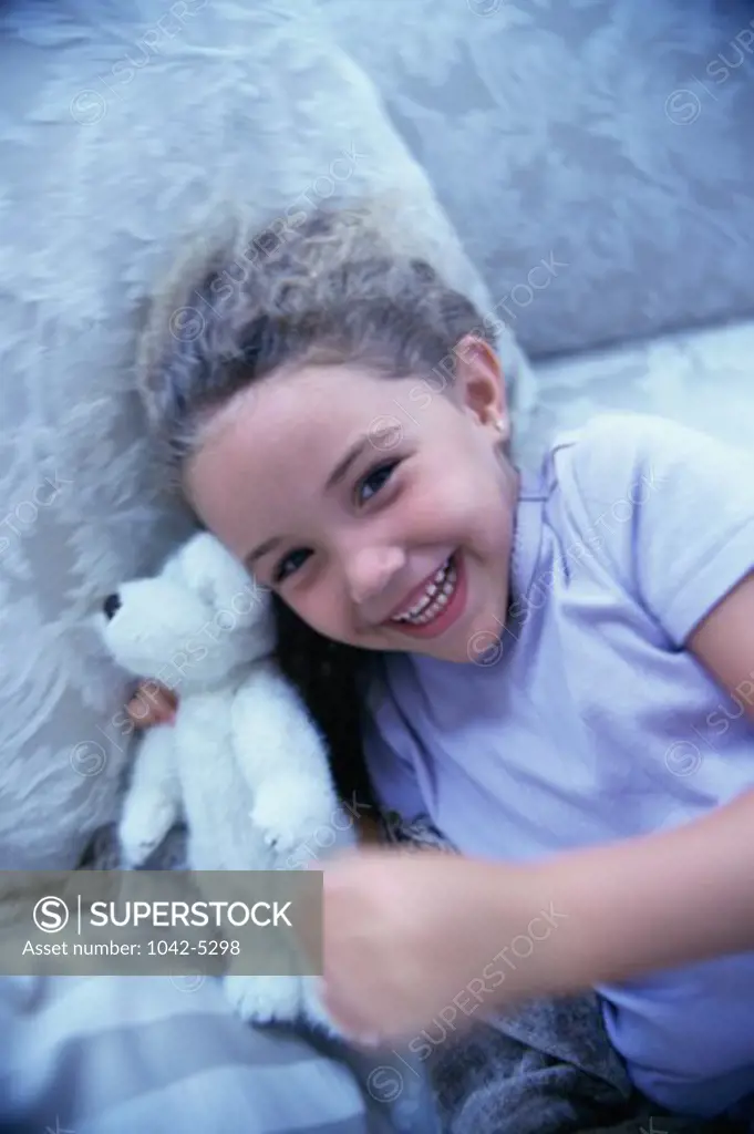 Portrait of a girl holding a teddy bear smiling