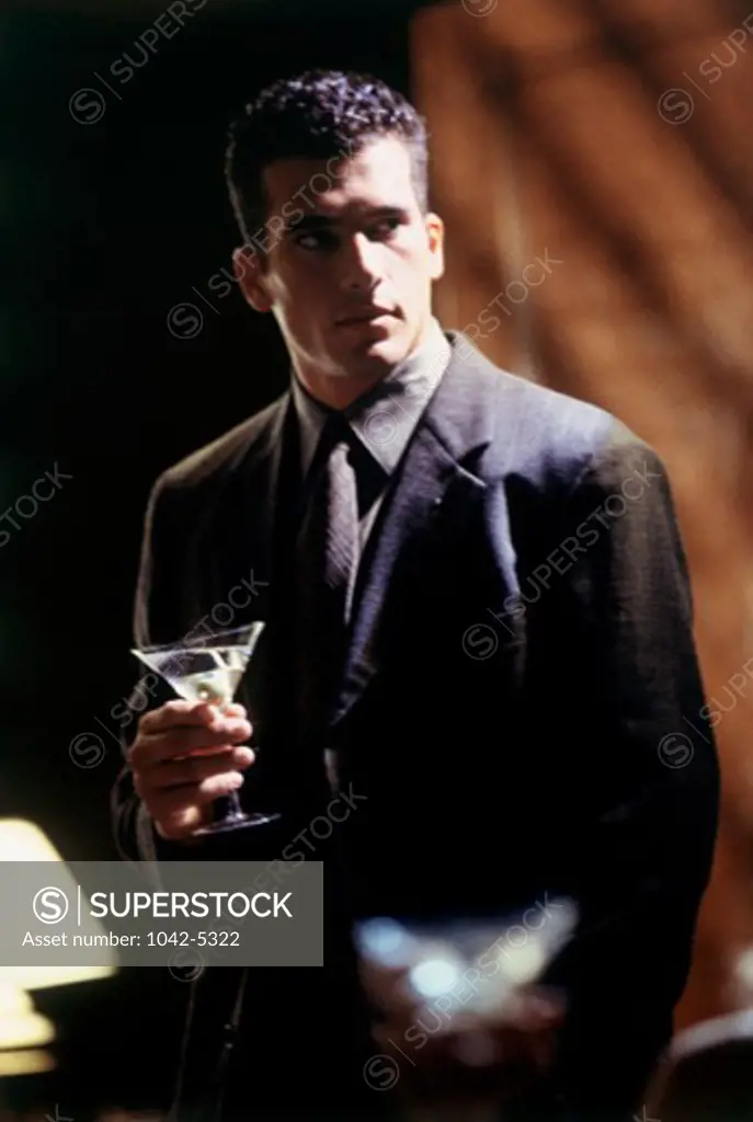 Young man holding a martini