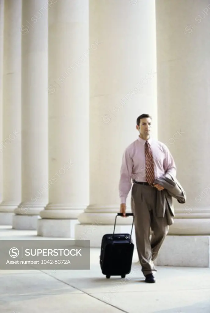 Businessman walking with luggage