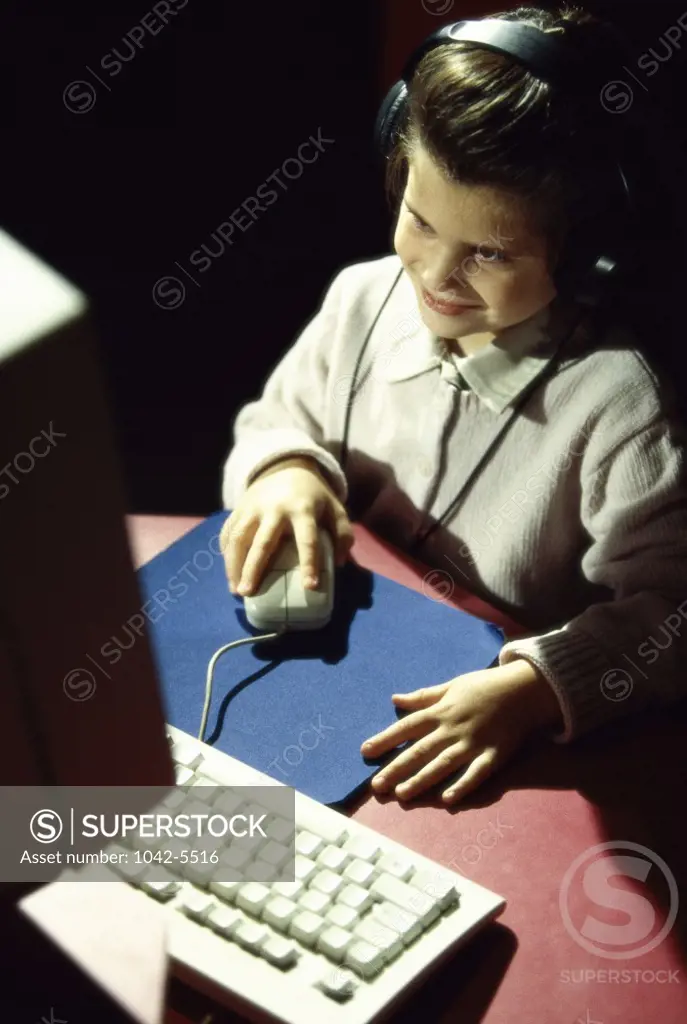 High angle view of a girl in front of a computer