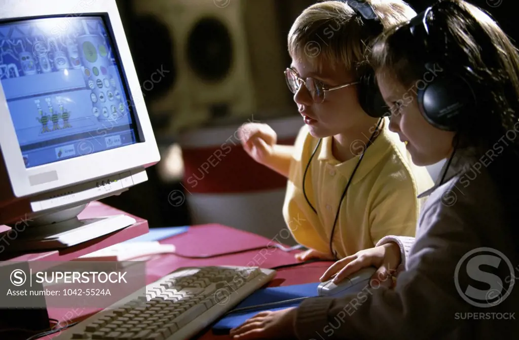 Boy and a girl in front of a computer