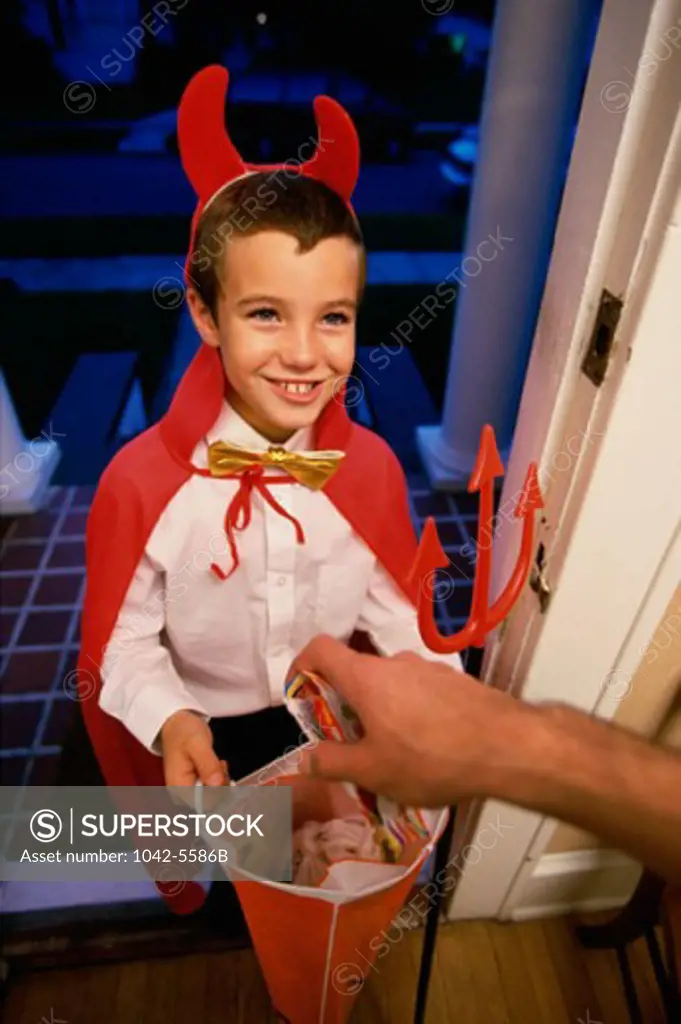 High angle view of a boy dressed as the devil on Halloween