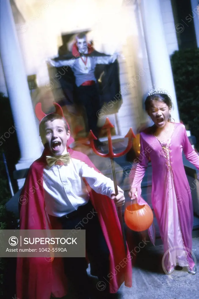 Boy and a girl in Halloween costumes