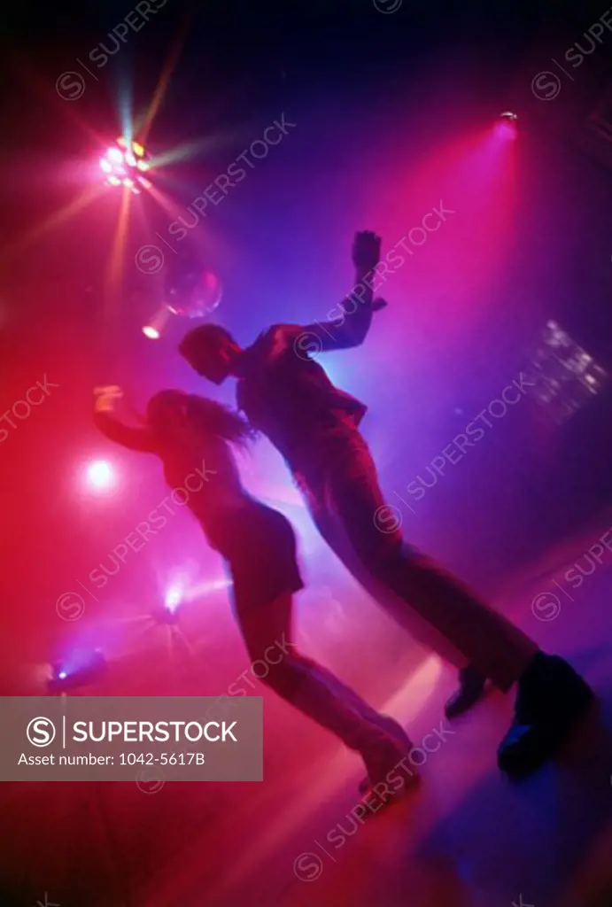 Low angle view of a young couple dancing in a nightclub