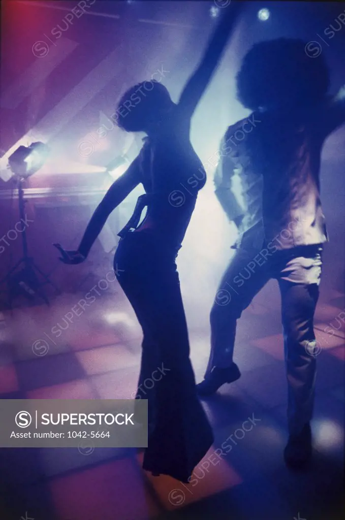 Silhouette of a man and a woman dancing on a dance floor