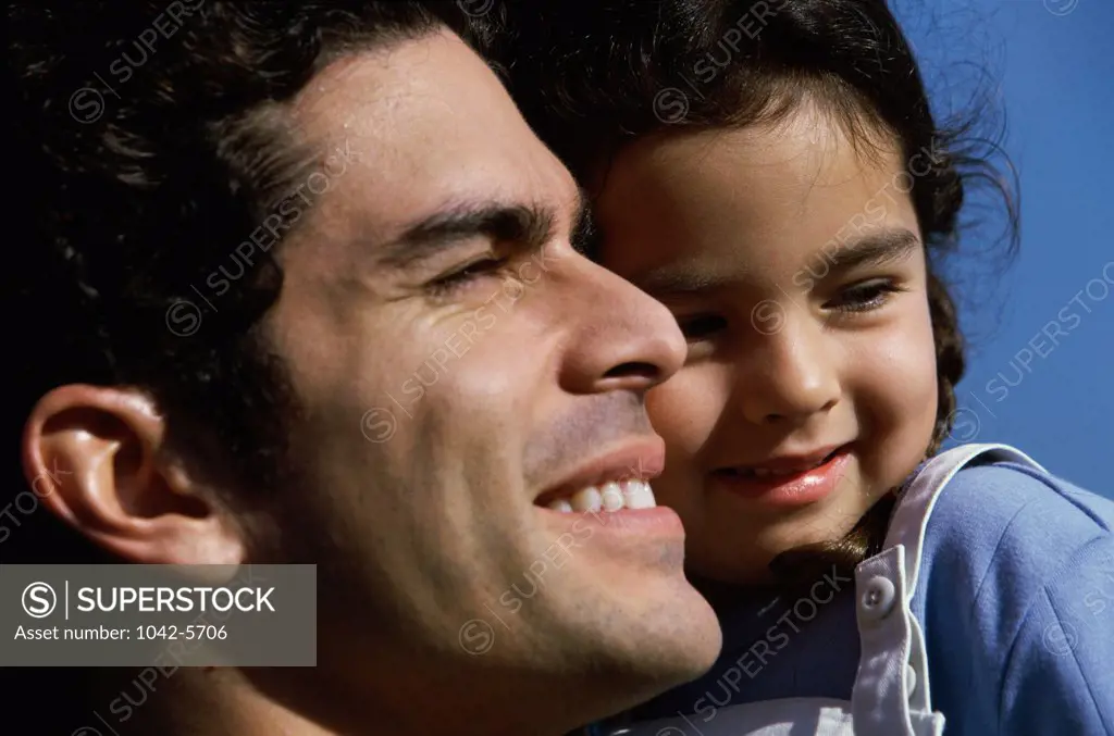 Close-up of a man holding his daughter