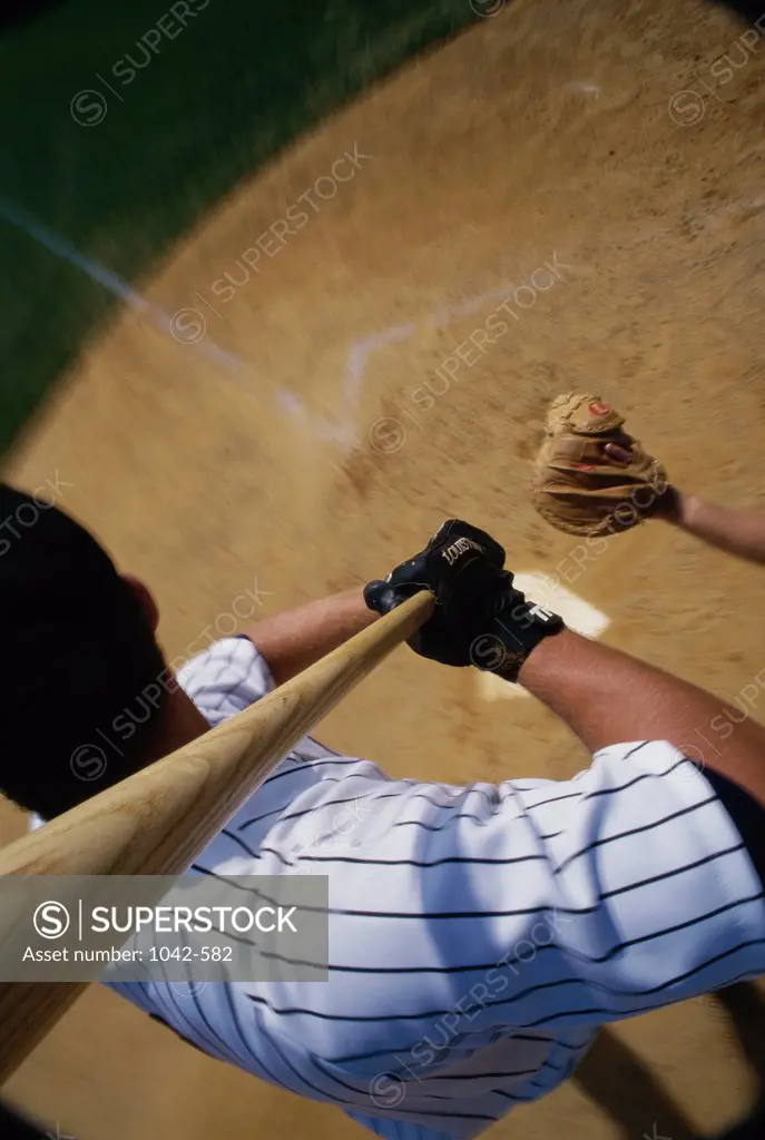 High angle view of a baseball player swinging a baseball bat