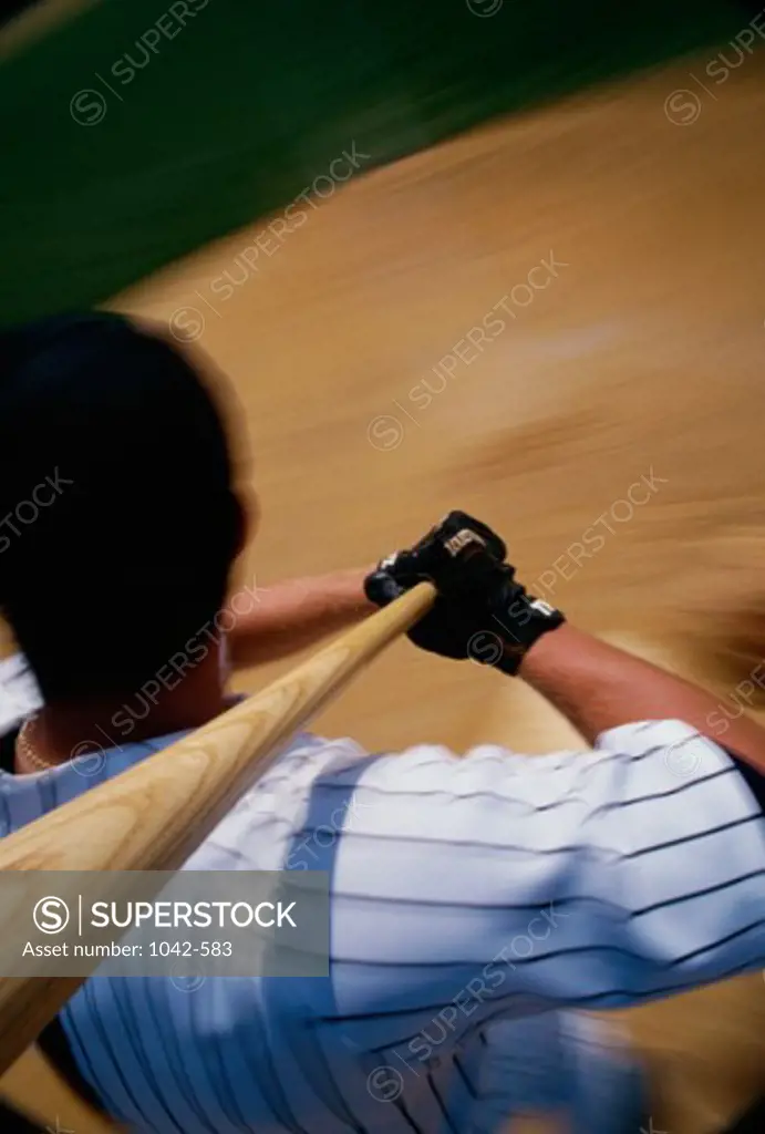 High angle view of a baseball player swinging a baseball bat