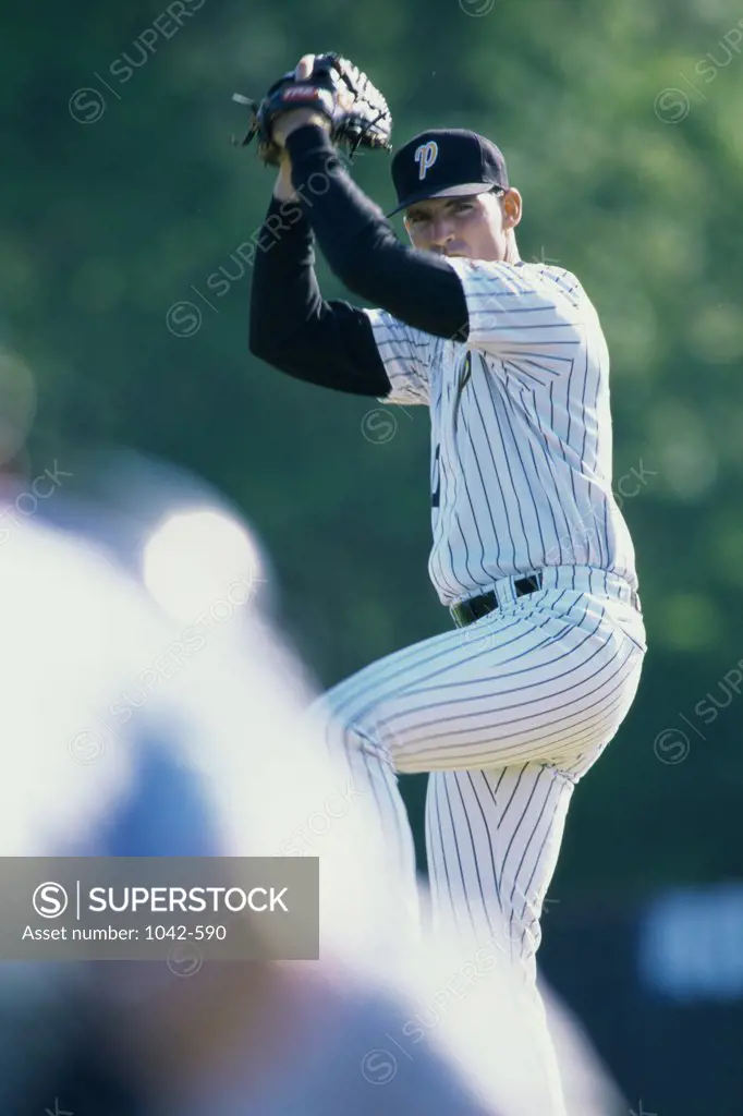 Baseball player pitching a baseball